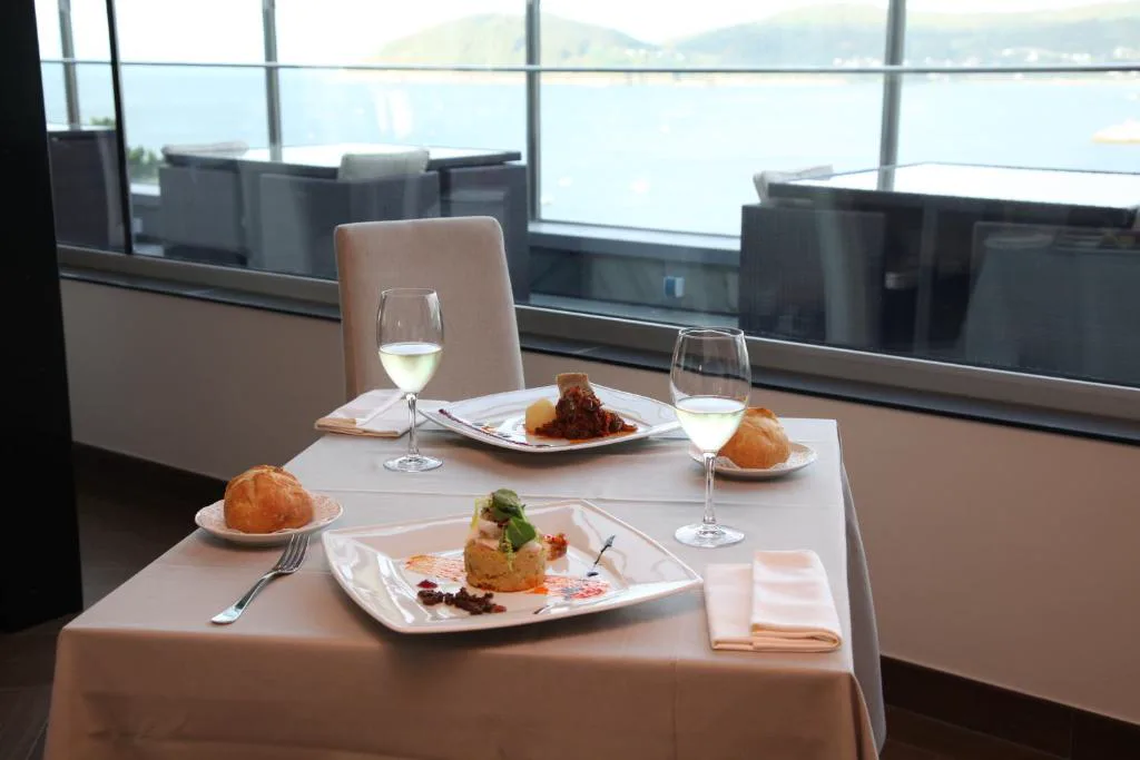 Mesa de restaurante vestida con vistas a la ría de Viveiro, Apartamentos Las Sirenas