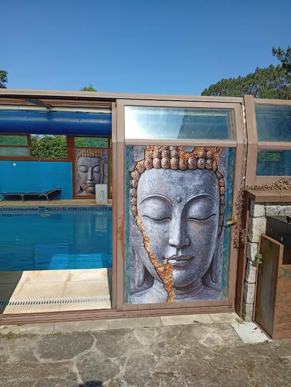 Piscina cubierta junto a un mural de Buda de piedra, Casa Buda Conors & Spa Boutique
