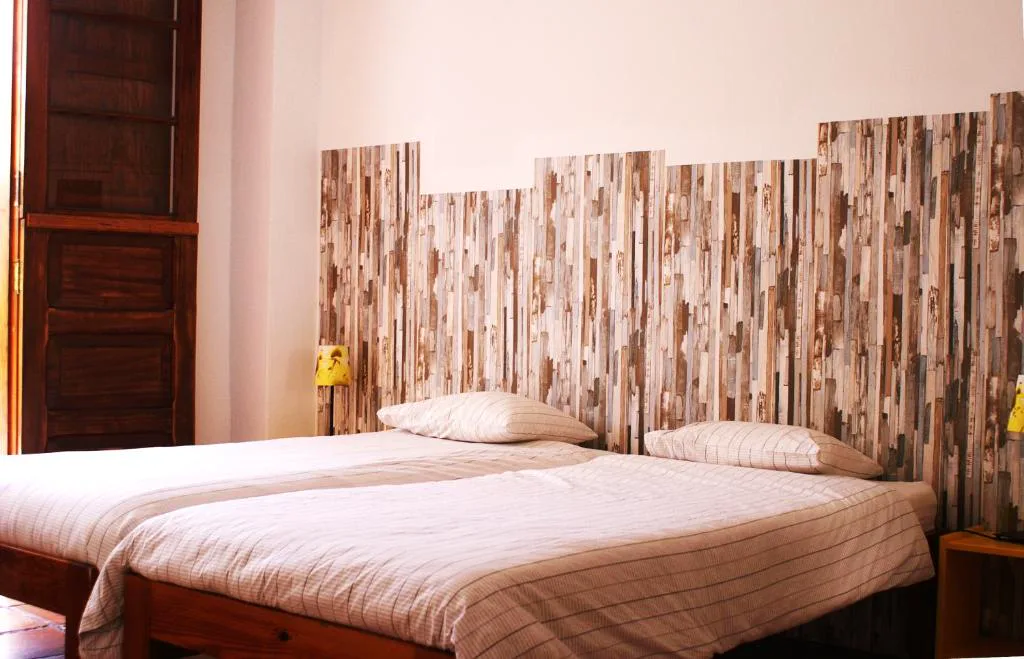 Dormitorio con cabecero de madera de tablones reciclados, Casa Creativa