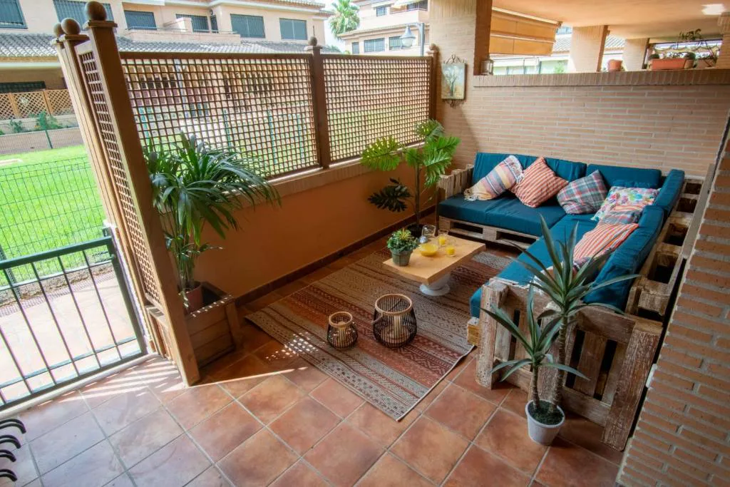 Terraza cubierta con sofás y cojines de colores