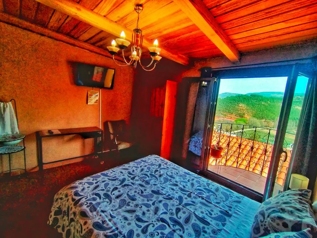 Habitación con bañera de hidromasaje y balcón