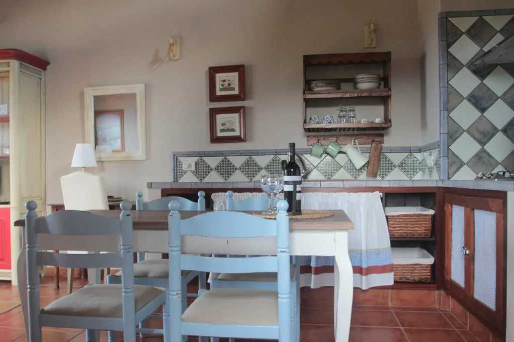 Cocina tradicional con azulejos de rombos y vajilla de loza, Casa Rural la Hojalata