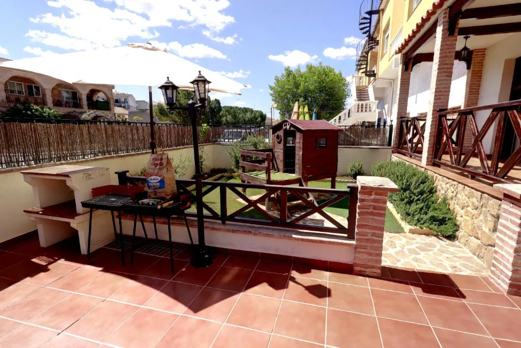 Terraza con sofás y suelo de baldosa roja
