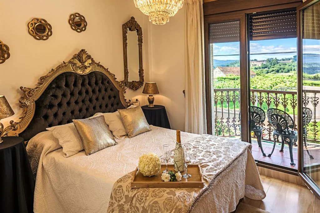 Habitación romántica con cabecero dorado, espejos antiguos y balcón con vistas, Casa Victoria