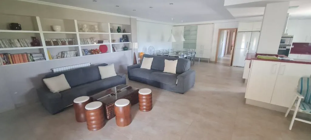 Salón con estantería y sofá gris