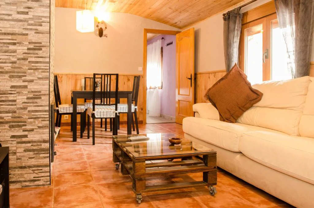 Salón con sofás claros y mesa de madera