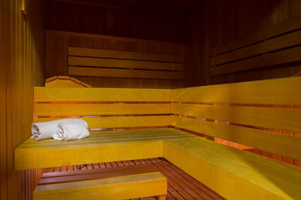 Sauna de madera con toalla blanca