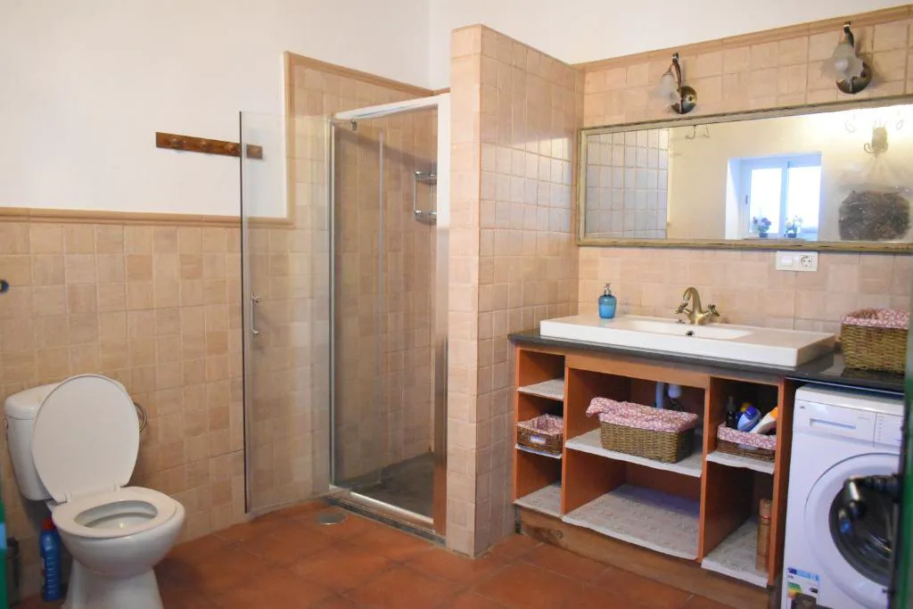Baño con ducha de obra y azulejos tradicionales, Finca Mariola