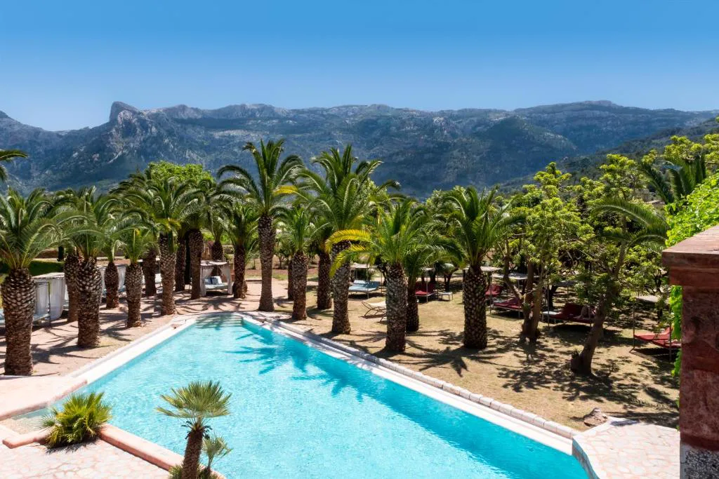 Piscina bordeada de palmeras con vistas a la Serra de Tramuntana, Hotel Finca Ca N'ai, Sóller, Mallorca
