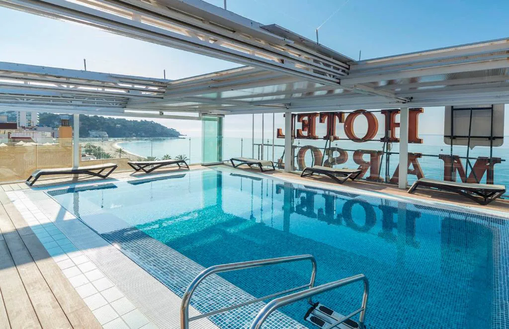 Piscina acristalada en la azotea con el nombre del hotel