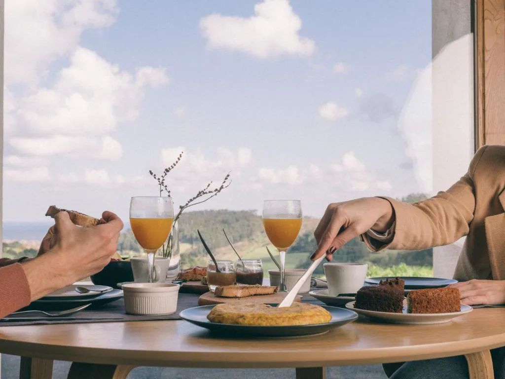 Desayuno con zumos y tortilla frente a la ventana
