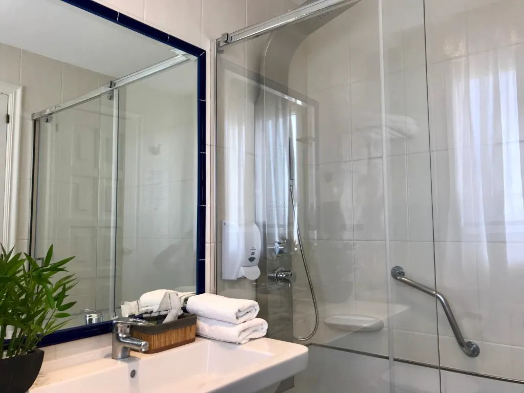 Baño con ducha de mampara y set de toallas, Hotel Nuevo Vichona