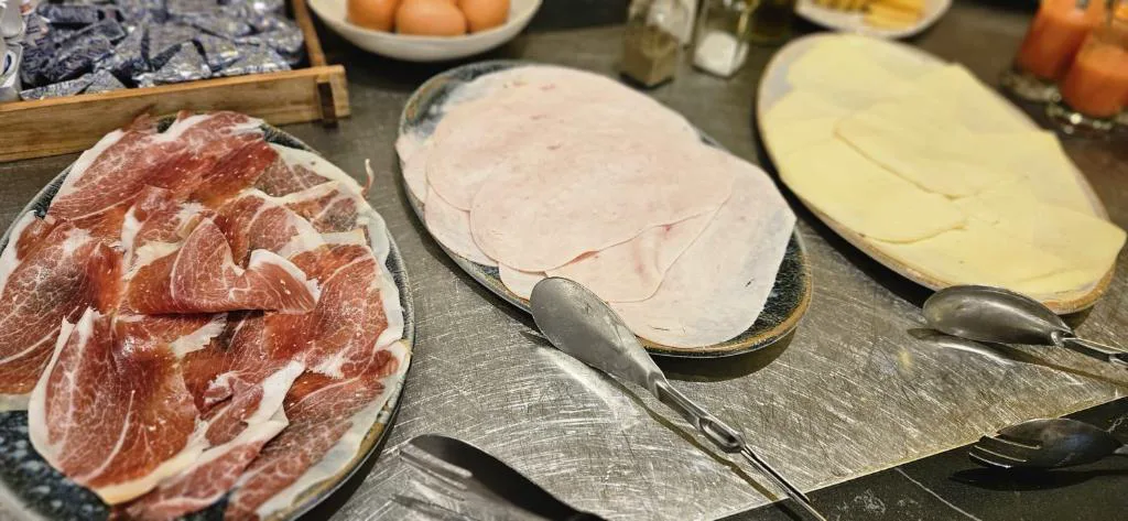 Buffet de desayuno con jamón, queso y embutidos