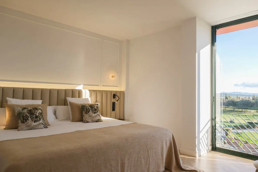 Habitación con cabecero claro y ventanal