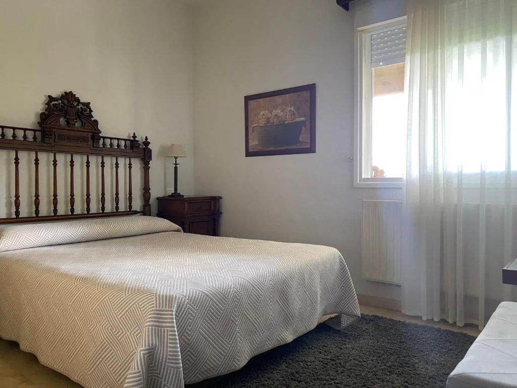 Dormitorio con cama de forja