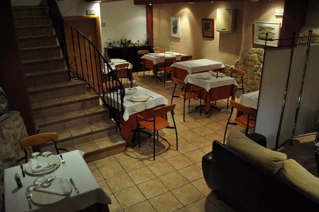 Restaurante con mesas y escalera de madera