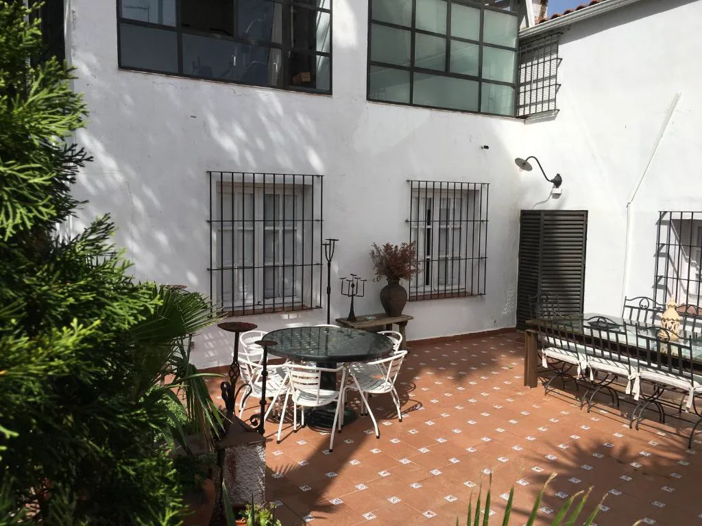 Patio con fachada blanca y ventanas