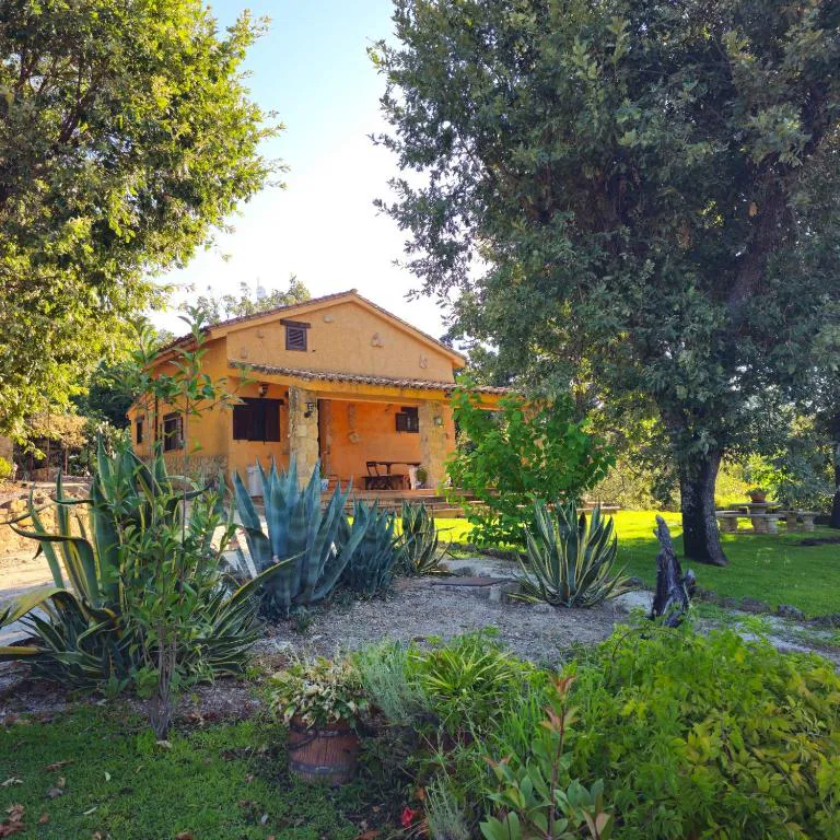 Casita de madera entre árboles y arbustos en un jardín