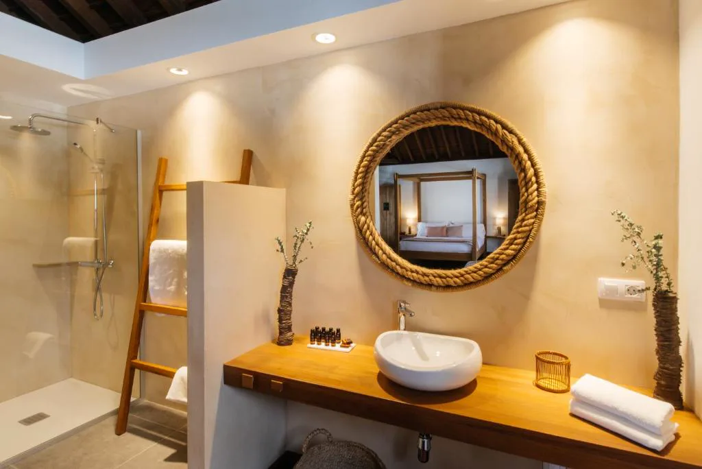 Baño con espejo circular de cuerda y ducha de obra, Hotel Boutique Palacio Ico