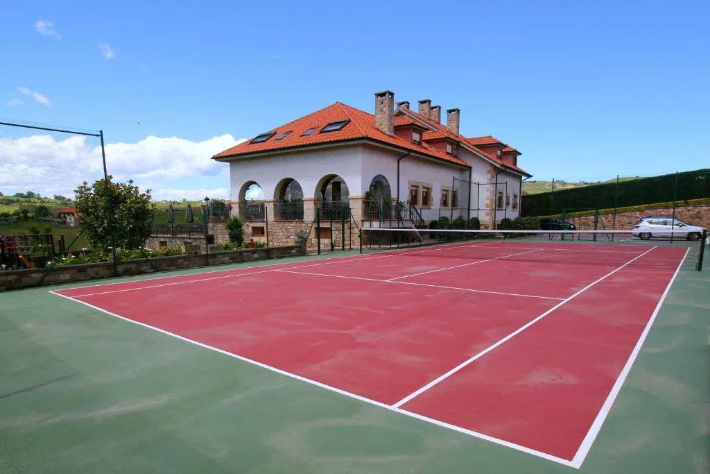 Casona con arcos junto a una pista de tenis