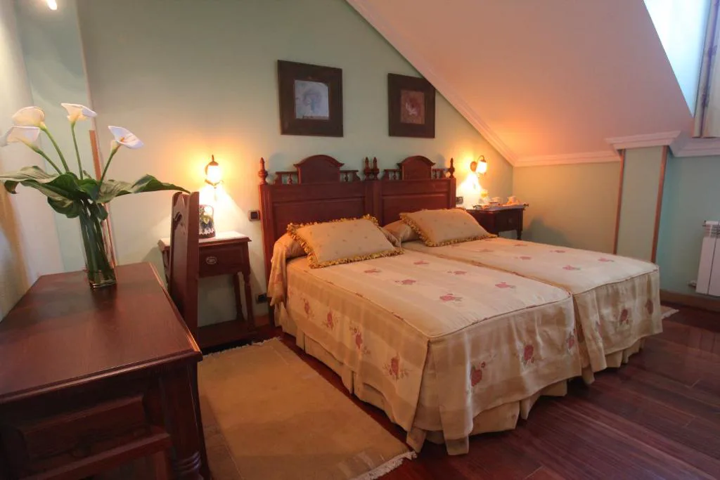 Habitación con dos camas y cabecero de madera