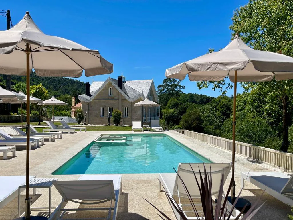 Piscina infinita de agua salada junto a la villa, rodeada de jardín y bosque, Villa Boutique 1880